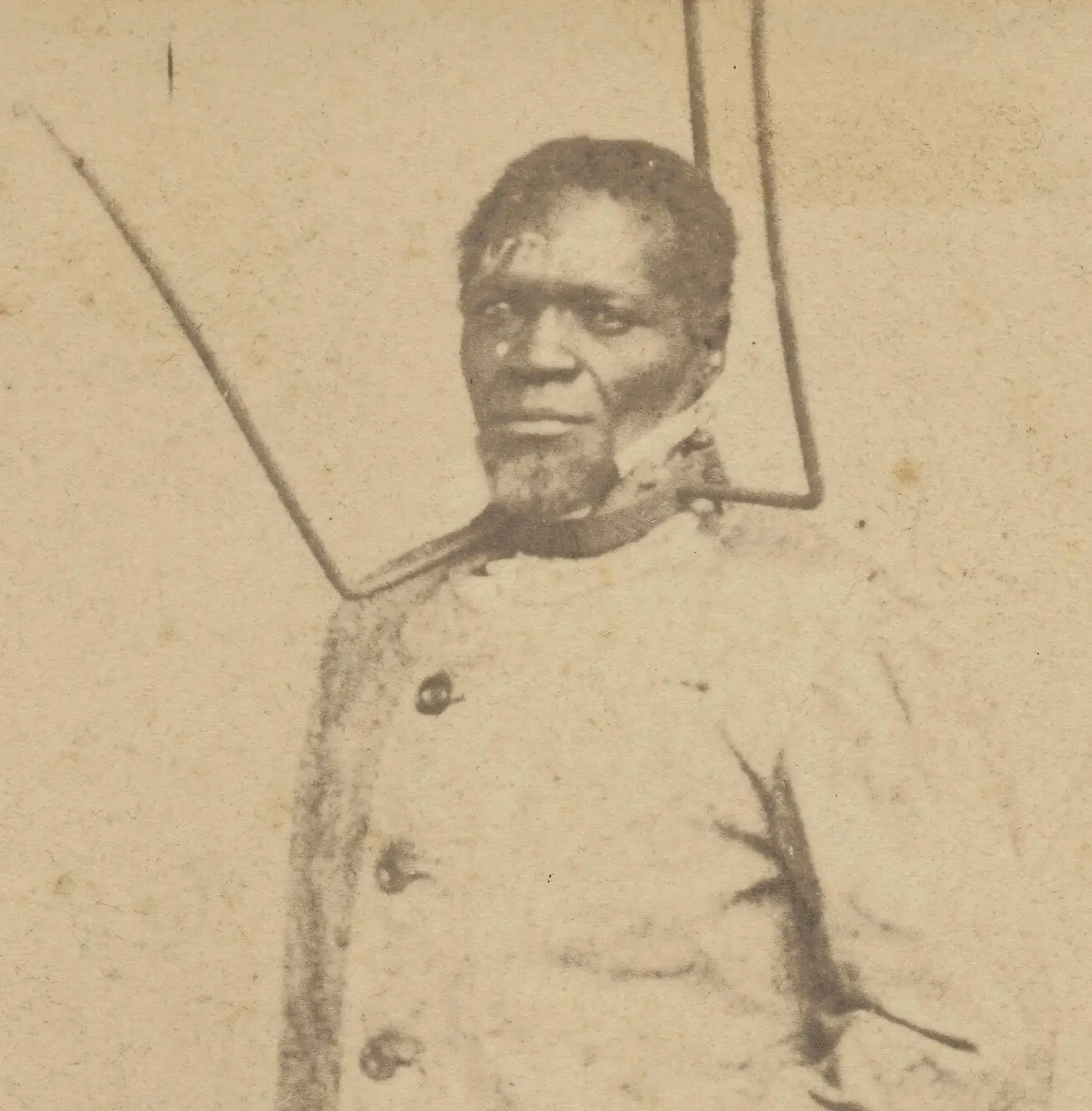 Photograph of an African American man in a three-pronged punishment collar.