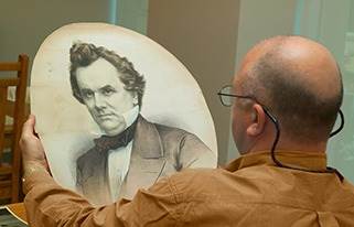 Man holding image of Stephen Douglas